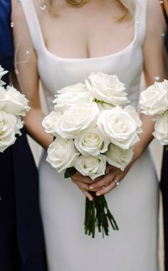 the bride and groom are holding their bouquets