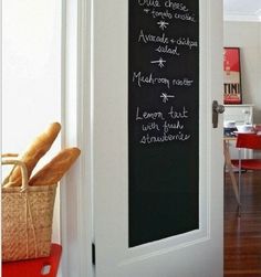 the chalkboard is on the wall in front of the door to the dining room