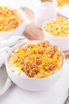 two bowls filled with macaroni and cheese on top of a table