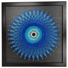 a blue and white circular object is in a black frame