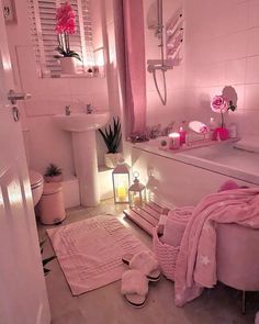 a white bathroom with pink decor and lights