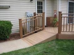 a wooden deck in front of a white house