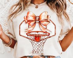 a woman wearing a t - shirt with an image of a basketball net on it