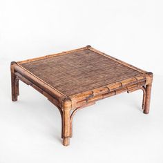 a coffee table made out of wood and wicker with an attached tray on top