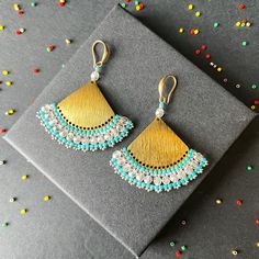 These earrings epitomize craftsmanship, utilizing top-tier branded beads such as Miyuki Delica beads and TOHO seed beads. Meticulously handcrafted with a robust beading thread, these earrings guarantee enduring shape retention and bead stability, even with continuous wear. A diverse spectrum of color combinations is available to cater to individual preferences, while all metallic components are expertly fashioned from high-quality brass. Hypoallergenic earring hooks prioritize wearer comfort and safety. Each design in the shop reflects a profound commitment to artistry, characterized by painstaking attention to detail.  Importantly, please consider potential slight variations in product color due to lighting and monitor calibration. Recommended care guidelines include precautions against w Handmade Gold Beaded Drop Earrings, Gold Dangle Earrings With Tiny Beads, Gold Earrings With Tiny Beads For Gifts, Bohemian Gold Earrings With Tiny Beads, Brass Beaded Earrings With Tiny Beads As Gift, Brass Beaded Earrings As Gift, Brass Beaded Earrings For Gifts, Handmade Gold Beaded Earrings, Silver Earrings With Gold Beads As Gift