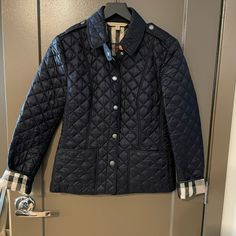 I’ve Selling My Beautiful Classic Burberry Jacket. Its A Light Jacket Great For Fall And Spring. The Color Is Dark Navy. Womens Size Small. I Normally Wear Size 2-4 For Jackets And Coats. It’s Been Worn But I’m Good Condition. There Are No Rips Or Loose Stitching. Luxury Navy Long Sleeve Outerwear, Designer Navy Long Sleeve Outerwear, Luxury Long Sleeve Quilted Jacket For Work, Luxury Quilted Jacket For Work, Burberry Jacket, Light Jacket, Dark Navy, Down Jacket, Burberry