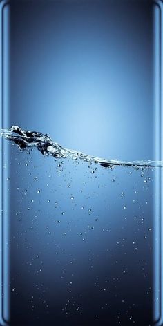 the back side of a cell phone with water splashing on it and an empty screen