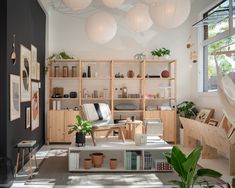 a living room filled with furniture and lots of plants