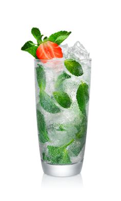 a tall glass filled with ice, mint and a strawberry on the top that is half full