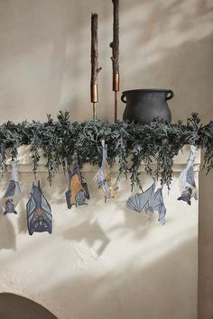 some paper bats are hanging from a mantle