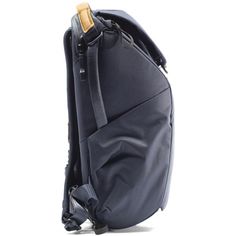 the back side of a black backpack on a white background