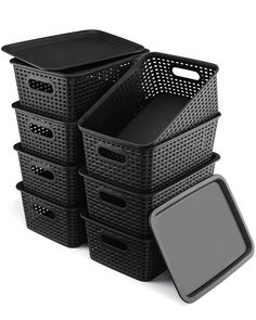 several black baskets stacked next to each other on a white surface with a gray lid