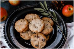 a black plate topped with cookies and apples