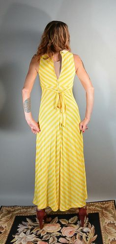 Great little summer dress, long 70s maxi dress bright yellow with stripes and butterfly collar. Super soft cotton dress, fits like a small or XS, I am a size 4 and I had a hard time zipping it up in back. All measurements taken while garment is laying flat. Excellent condition armpit to armpit 15 inches (30 around) empire waist 25 or 26 inches around does have some stretch nape to hem 54 inches Retro V-neck Maxi Dress For Summer, Striped V-neck Maxi Dress For Spring, Spring Vintage V-neck Maxi Dress, Vintage V-neck Maxi Dress For Spring, Striped Fitted Maxi Dress For Summer, Retro Summer Maxi Dress With V-neck, Retro Striped Spring Dresses, Retro Striped Dresses For Spring, Spring Party Striped Maxi Dress