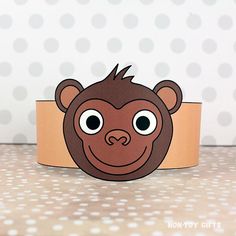 a paper cup with a brown monkey on it's face and polka dots in the background