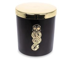 a black and gold canister with a snake on the side, in front of a white background