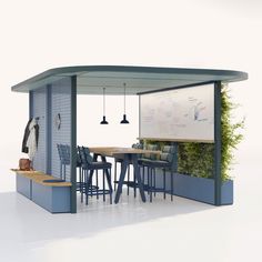 an outdoor kitchen with blue chairs and a white board on the wall, next to a dining table