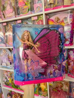 a barbie doll in a pink dress and butterfly wings on display at a toy store