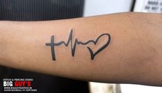 a person with a heart and heartbeat tattoo on their arm