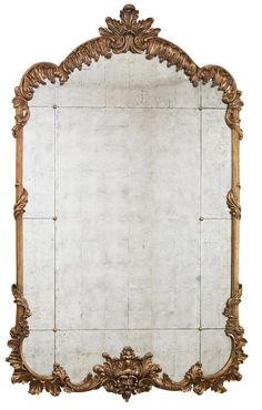 an ornate gold framed mirror against a white background