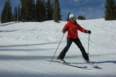 a person on skis in the snow with trees in the backgroung