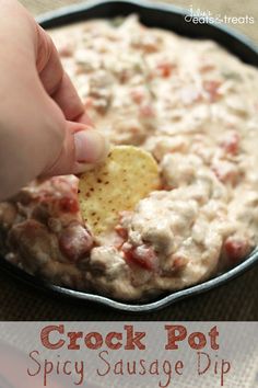 a person dipping a cracker into a bowl of dip