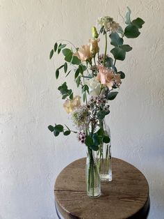 a vase filled with flowers sitting on top of a wooden table