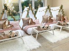 a room filled with lots of white furniture and pillows on top of it's sides