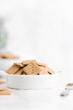 a white bowl filled with crackers on top of a table