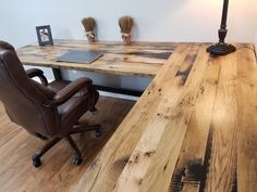 a chair and desk made out of wooden planks in a room with white walls