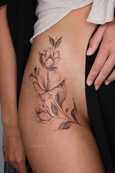 a close up of a person's stomach with flowers on it