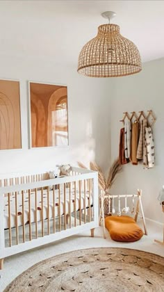 a baby's room with a crib, rug and pictures on the wall