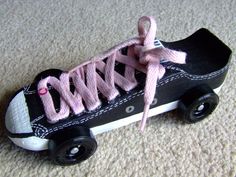 a black and white skateboard with pink laces on the top, sitting on carpet