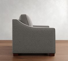 a gray couch sitting on top of a wooden floor