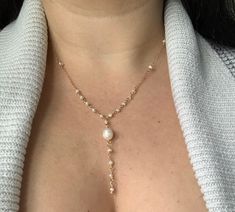 This timeless and dainty freshwater baroque pearl lariat Y necklace would be the perfect bridal necklace for the big day - or simply to dress up any outfit! Handmade from 14k Gold Filled wire and chain, and genuine pearls, this necklace can get wet and will last for years to come with minimal care.  This necklace is available in 14, 16, 18 or 20 inch lengths. Pearl beads measure 3 mm to 11 mm in size. Each pearl is hand-picked during the crafting of each necklace to show range of size and textur Minimal Pearl Necklace, Delicate Single Strand Bridal Necklace For Wedding, Elegant Pearl Lariat Necklace For Wedding, Pearl Lariat Backdrop Necklace For Weddings, Adjustable Lariat Necklace With Pearl Charm For Wedding, Elegant Pearl Drop Lariat Necklace For Wedding, Elegant Wedding Pearl Lariat Necklace, Pearl Lariat Necklace For Wedding, Gold Pearl Lariat Necklace For Wedding