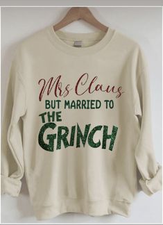 a white sweatshirt that says, mrs claus but married to the grinch on it