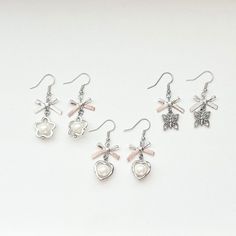 Cute and dainty silver bow earrings, perfect for sprucing up any outfit! Comes in 3 variations, perfect for anyone! -made with heavy duty jump rings!! -handle with care! items are made to prevent any damage but they are still handmade so handle gently!  -all items are personally tested to ensure best quality -all orders come with freebies! Cute Silver Earrings With Bow, Silver Metal Earrings With Bow, Silver Dangle Earrings With Bow, Dainty Silver Bow Earrings, Dainty Silver Earrings, Glow Stars, Silver Bow, Bow Earrings, Pretty Jewellery