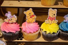 winnie the pooh cupcakes with frosting on them