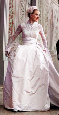 a woman in a wedding dress walking down the street