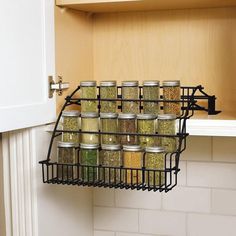 a rack with spices in it hanging from the wall