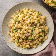 two bowls filled with macaroni and peas