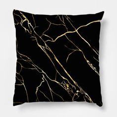 a black and gold marble pillow cover on a white background with an abstract design in the middle