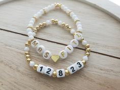 "This adorable bracelet set is perfect for a bride to be! The price is for both bracelets, but they can also be purchased separately if you only want one.  One bracelet says \"Mrs.\" and the bride's new last name. This bracelet is made with a gold 18k gold plated heart bead separating the Mrs. and the last name, white glass 4mm round beads, and 24k gold plated bumpy rondelle accent beads. It also has a gold plated round bead to cover the knot. The letters used are round white acrylic with gold l Bracelet Team Bride, Bride Clay Bead Bracelet, Gold Bracelets With Letter Beads For Wedding, Personalized Gold Beaded Bracelet For Wedding, Personalized Gold Beaded Bracelets For Wedding, White Charm Bracelet For Anniversary On Mother's Day, Personalized Gold Beaded Wedding Bracelets, Personalized Beaded Bracelet For Wedding, Personalized Gold Beaded Wedding Bracelet