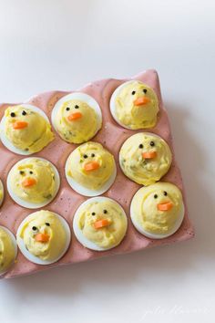 an egg tray with deviled eggs decorated like ducks