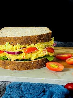 an egg salad sandwich with tomatoes and lettuce