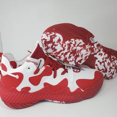 a pair of red and white sneakers on top of each other