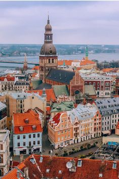 an aerial view of a city with many buildings and water in the backround