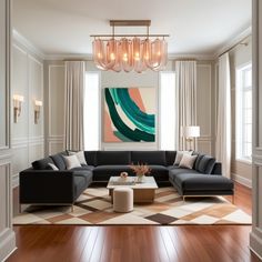 a living room filled with furniture and a chandelier hanging over the top of it