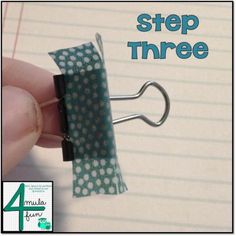 a hand holding a paper clip with the words step three