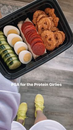 a person holding a tray with different types of food in it and the words psa for the protein grilles